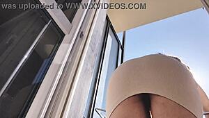 latina babe flashes shaved pussy and ass on balcony without panties