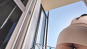 latina babe flashes shaved pussy and ass on balcony without panties