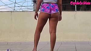 brunette's curvy ass cheeks peek from tucked-up shorts during outdoor training