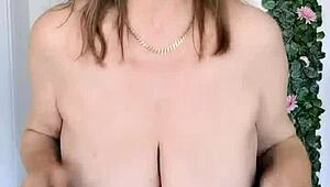 This horny busty gilf in stockings spreads wet pussy teasing big natural tits