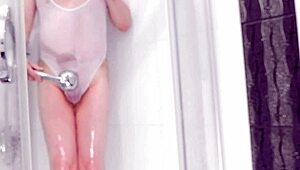 boy in see-through swimsuit plays with shower toy