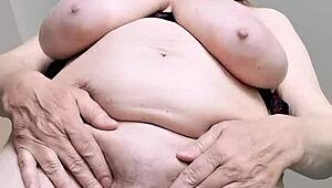 This horny busty gilf in stockings spreads wet pussy teasing big natural tits