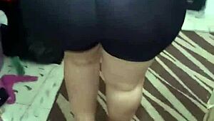 Shiny spandex clings to mature woman's huge jiggling ass cheeks during tease