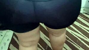 Shiny spandex clings to mature woman's huge jiggling ass cheeks during tease