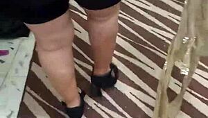 Shiny spandex clings to mature woman's huge jiggling ass cheeks during tease