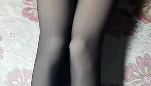 crossdresser strokes cock through black pantyhose jeans