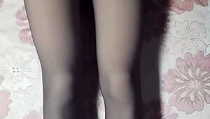 crossdresser strokes cock through black pantyhose jeans