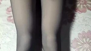 crossdresser strokes cock through black pantyhose jeans