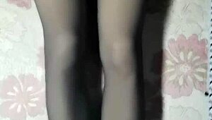 crossdresser strokes cock through black pantyhose jeans