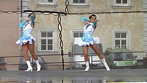 Two nice majorettes showcase cheerleader charm and precision moves