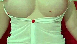 hey look at this pretty blonde in see-through dress squeezing her huge tits up close