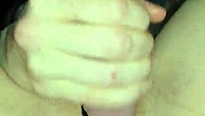 Glove-wearing milf milks cock with wet pierced nipples