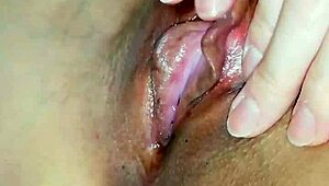 Horny Japanese slut rubs swollen clit close-up wet