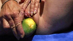 Watch her tease wet pussy with cucumber close-up for ultimate gaping clit pleasure