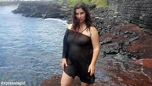 Curvy brunette flashes pussy and masturbates publicly on beach