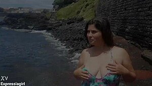 Curvy brunette flashes pussy and masturbates publicly on beach