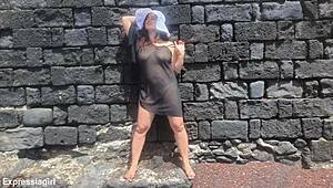 Curvy brunette flashes pussy and masturbates publicly on beach