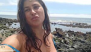 Curvy brunette flashes pussy and masturbates publicly on beach