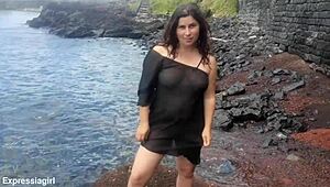 Curvy brunette flashes pussy and masturbates publicly on beach