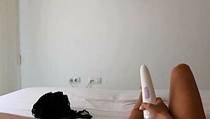 Milf watches her lesbian porn vid while fingering shaved pussy deep.