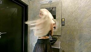 Curious blonde's big tits peek through see-through miniskirt sans panties.