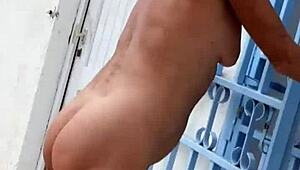 Nude blonde bares all in lush garden heels amid nature