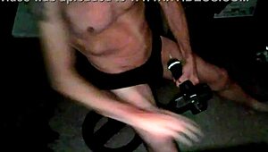 Skinny old woman applies percussion massager to thigh in underwear on stool