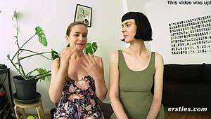 Two sexy German brunettes suck tits and kiss passionately in public hallway