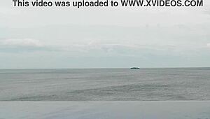 skinny japanese college girl in ponytail dips into infinity pool showing off legs and small waist