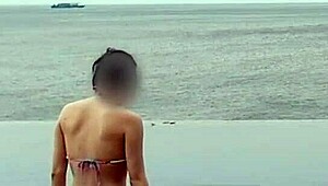 skinny japanese college girl in ponytail dips into infinity pool showing off legs and small waist