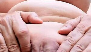 Busty granny spreads shaved pussy close-up masturbating hungrily