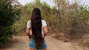 pretty tanned babe flashes natural tits while walking forest path