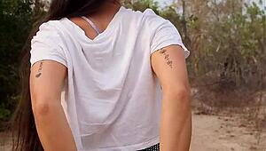 pretty tanned babe flashes natural tits while walking forest path