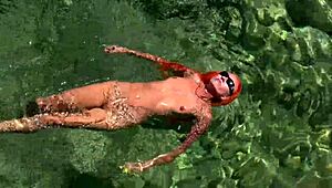 yellow trunks hug her curves against blue waves flashing wet shaved pussy outdoors