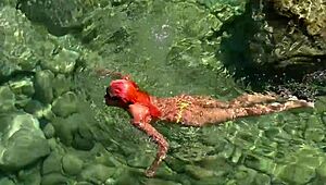 yellow trunks hug her curves against blue waves flashing wet shaved pussy outdoors