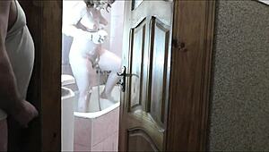 sexy blonde strips naked in bathroom as roommate jerks off watching her wet folds