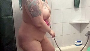 Chubby Tattooed Babe Teases Wet Pussy in Shower!
