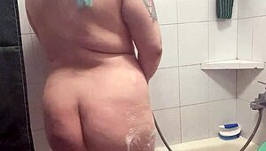 Chubby Tattooed Babe Teases Wet Pussy in Shower!