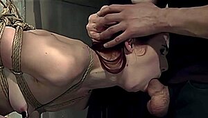 redhead slave endures master's strict rope bondage with hard mouth fucking and spanking