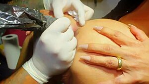 whoa tattooing that whore's tight ass hole while the artist inks her gaping anus 😈🔥