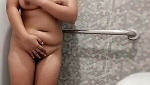Sexy Filipina showers bubbly water over huge natural boobs