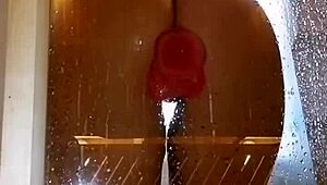 girl with an appetizing ass is having fun in the shower with a pink dick