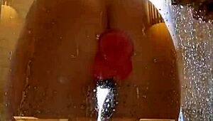 girl with an appetizing ass is having fun in the shower with a pink dick