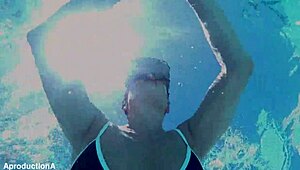 two girls go underwater for lesbian strap on sex outdoors