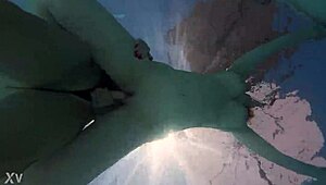 two girls go underwater for lesbian strap on sex outdoors