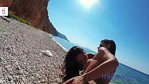 Greek milf enjoys public threesome on beach.