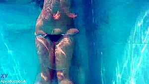 two girls go underwater for lesbian strap on sex outdoors