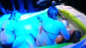 sexy lesbians oil up and wrestle