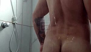 a masked tattooed man takes a shower alone and enjoys playing with his toy until he cums